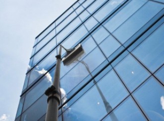 Image of the Pure Water pole-fed industrial window cleaning system in action