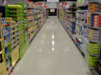 Image of a clean, polished supermarket isle floor professionally cleaned by Fusion Property Services